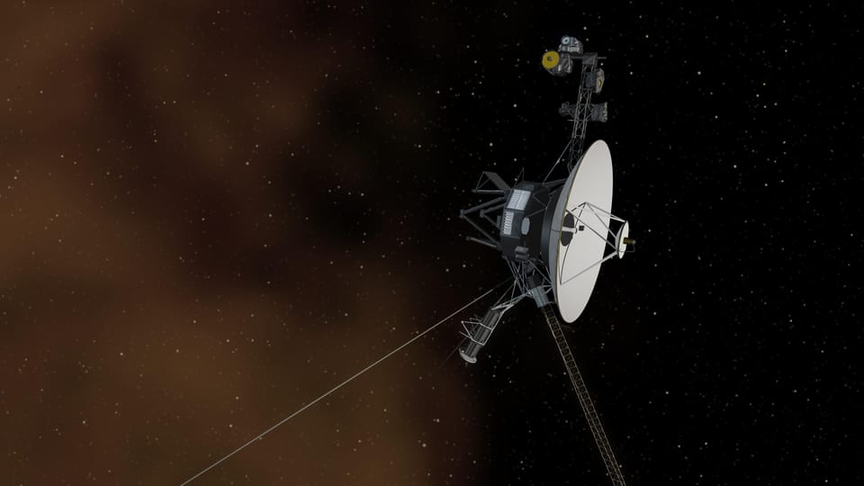 A spacecraft consisting mainly of a large dish, two long antenna and various attached instruments amid a backdrop of stars. 